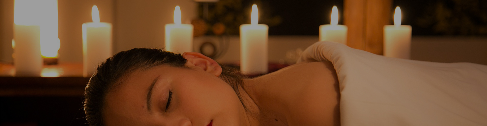 A guest enjoying a relaxing spa treatment by candlelight